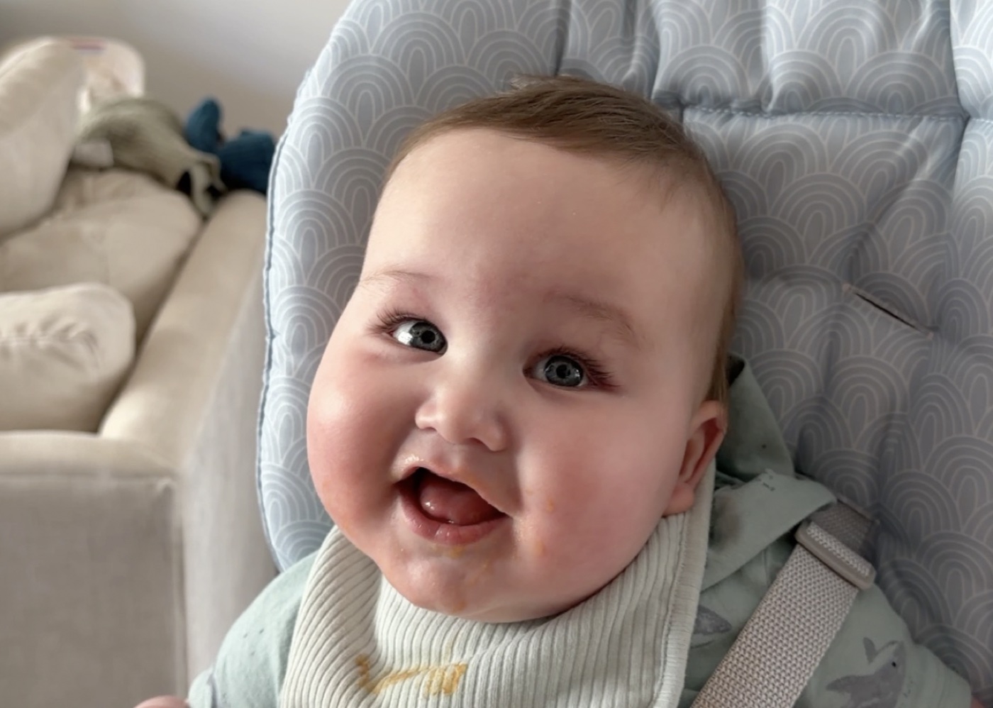 Teddy, smiling in his high chair